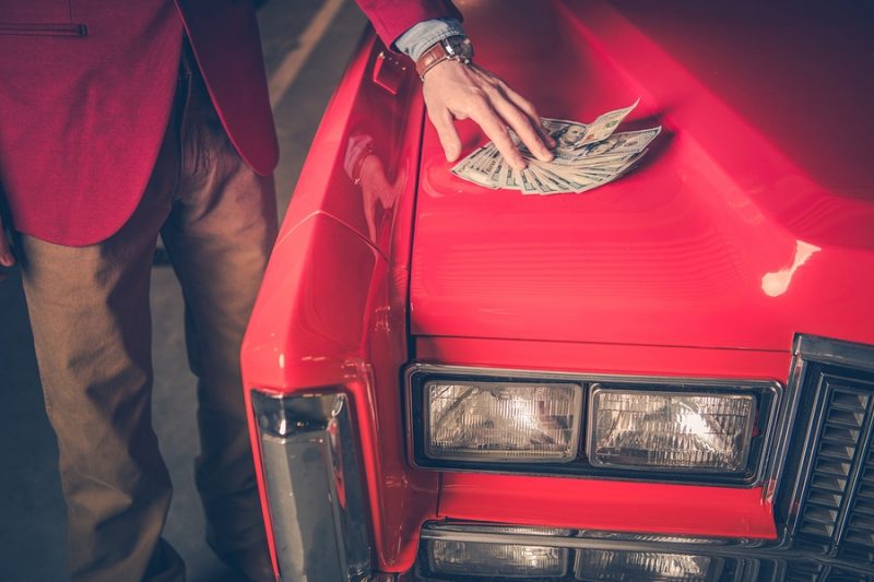 Buying Pre Owned Car Men Placing Cash Dollars Deposit For The O